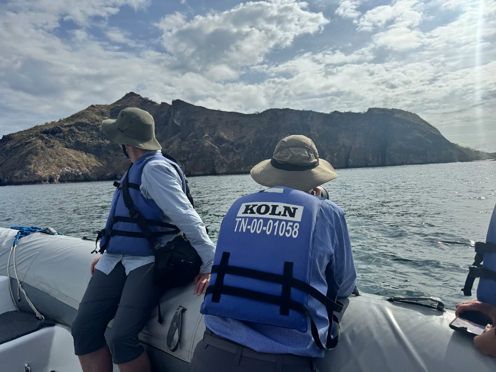 Guests on a panga ride approaching a Galápagos island
