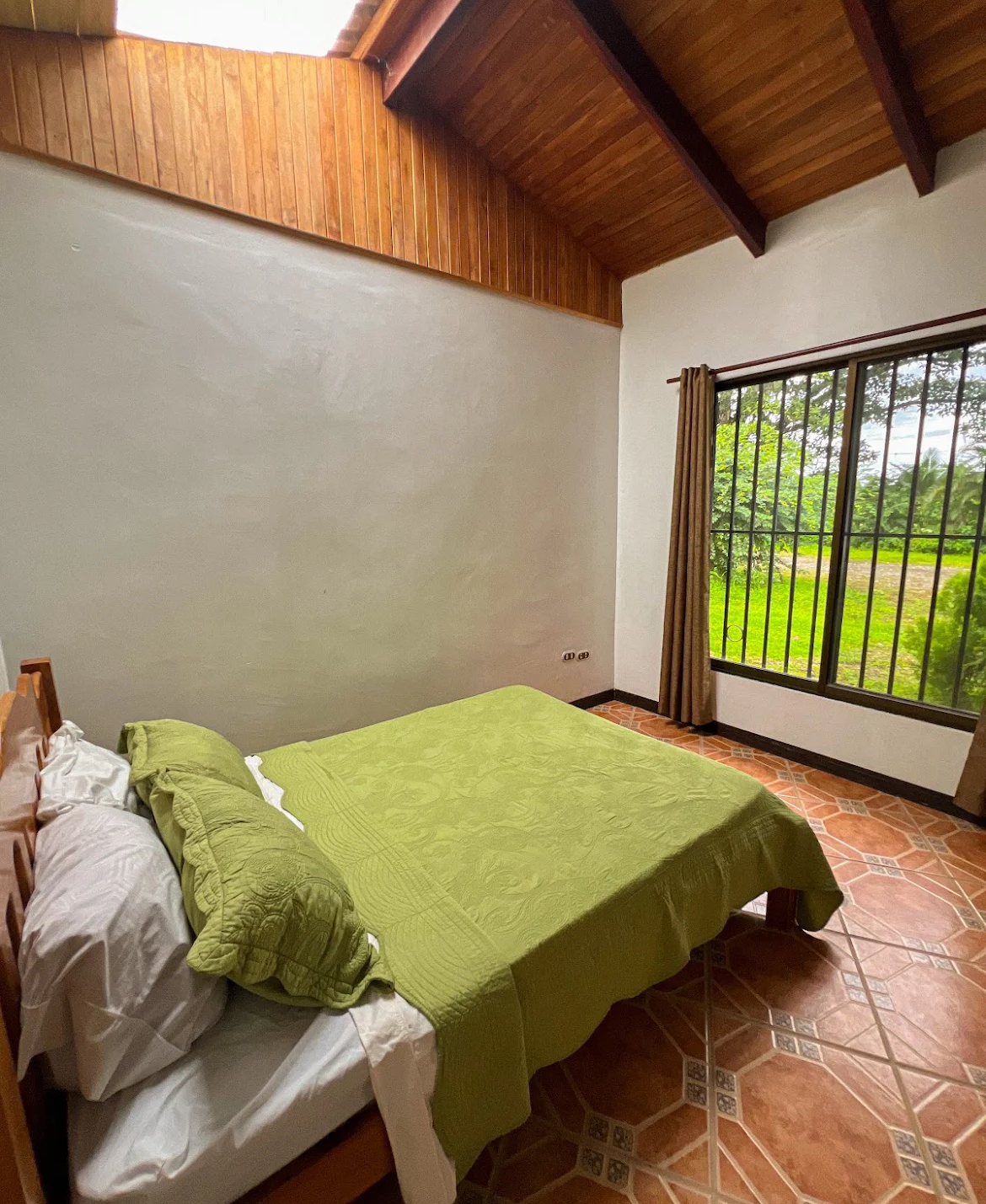 A private bedroom in the house with a double bed and views over the garden