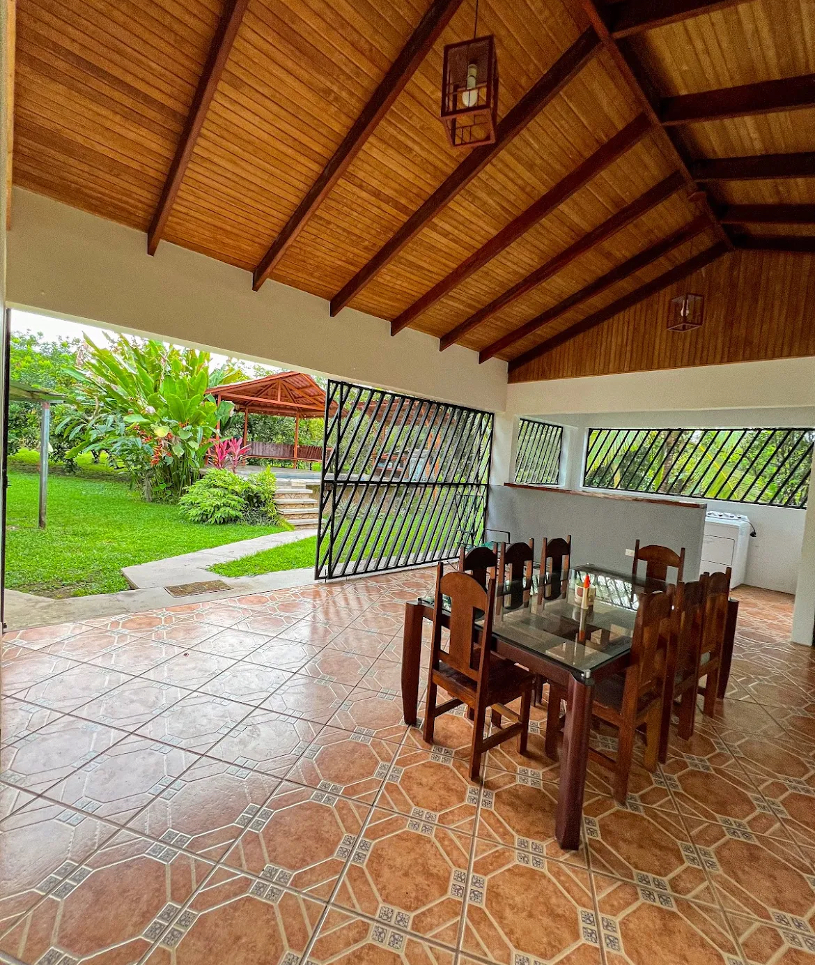Covered outdoor dining terrace looking out over the tropical gardens